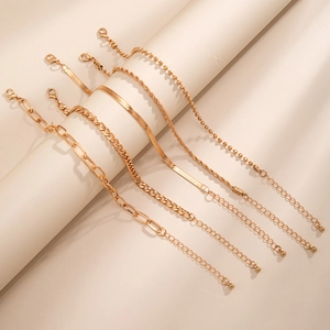 5-piece gold-tone layered anklet set featuring snake, twist, and beaded chain styles