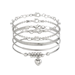Five-piece silver anklet set featuring heart charms, bead chains, and snake chain layers
