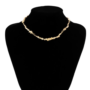 Detailed view of golden irregular lava-style choker necklace on a black mannequin
