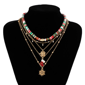 Detail of layered Christmas necklace featuring clay beads, gift box and snowflake charms