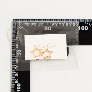 Detailed size measurement of gold star hoop earrings on a fashion jewelry display card