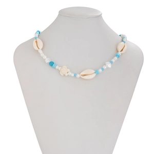 Detail of beach ocean style beaded necklace featuring sea turtle and natural shells