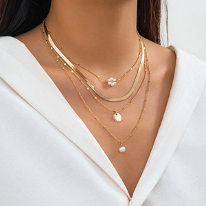 Minimalist layered gold necklace set with snake chain and elegant pearl pendants