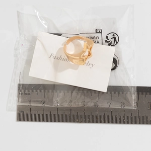 Detailed view of adjustable hollow star ring with measuring scale and packaging