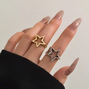 Chic gold and silver hollow star ring set worn on hand for a minimalist aesthetic