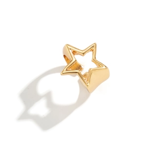 Macro detail of wide hollow star ring with polished gold finish and modern geometric lines