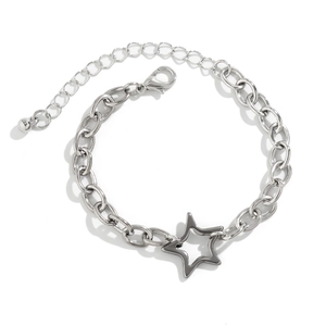 Detailed macro view of the silver star pendant on a thick oval link chain bracelet