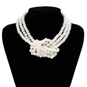 Elegant multi-layer pearl choker necklace with decorative knot design on black mannequin