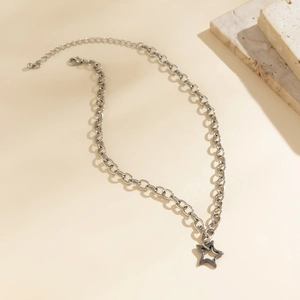 Detail of silver star pendant on minimalist industrial chain link necklace with clasp