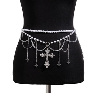Detail of layered pearl waist chain with silver metal tassels and rhinestone crosses