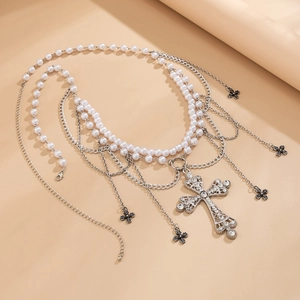 Detailed view of vintage multi-layer waist chain with faux pearls and cross pendants