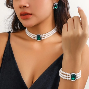 Three-layer pearl choker set with emerald-cut green gemstones and matching earrings