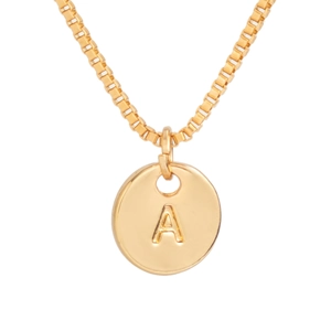Close-up of gold disc pendant with engraved letter A on a box chain necklace
