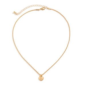 Detail of gold box chain and round pendant featuring engraved letter D with lobster clasp