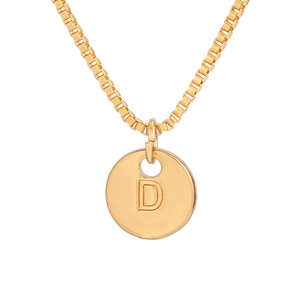 Detailed macro view of a gold-plated box chain and circular pendant featuring the letter D