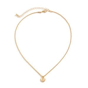 Detailed close-up of a golden box chain with engraved initial E round pendant