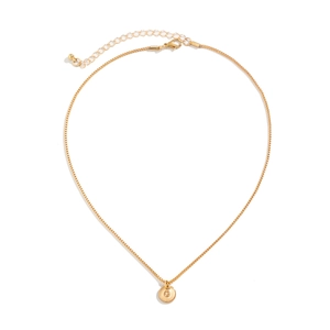 Detailed macro of gold box chain and engraved letter G round pendant with lobster clasp