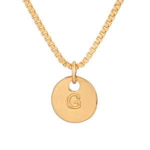 Detail of gold coin pendant with embossed letter G on a classic box chain necklace