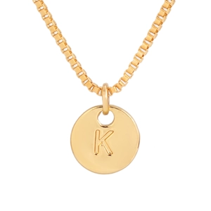 Macro shot of gold box chain necklace with engraved letter K on a round pendant