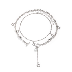 Close-up of silver layered necklace with star charms and vintage OT toggle clasp detail