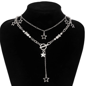 Detail of layered silver star necklace with OT toggle clasp on a black neck mannequin