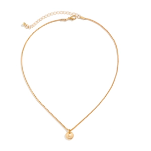 Macro shot of minimalist gold round pendant necklace featuring engraved letter L detail