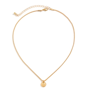 Detail of gold box chain necklace with circular letter C engraved pendant and lobster clasp