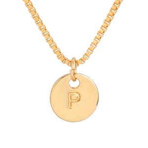 Macro shot of gold box chain and round pendant featuring engraved letter P detail