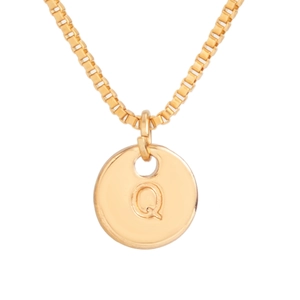 Macro detail of golden box chain and round pendant with engraved letter Q for women