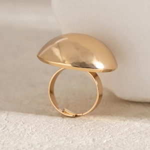 Detail of a minimalist gold mushroom ring with polished pleated dome and adjustable band
