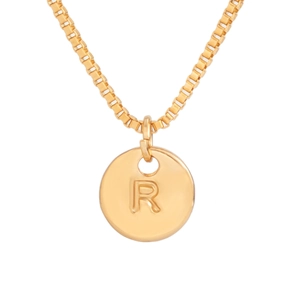 Detail of a round gold pendant featuring a raised letter R with a classic box chain