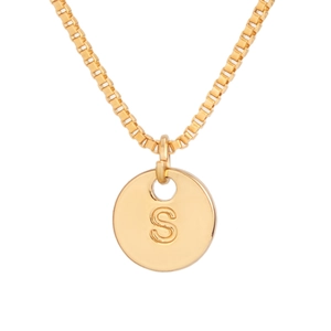 Detail view of gold box chain necklace with polished round pendant engraved with letter S