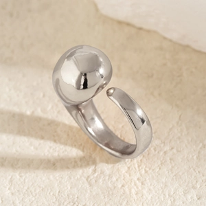 Detail of silver irregular sculptural flower ring with polished liquid metal texture