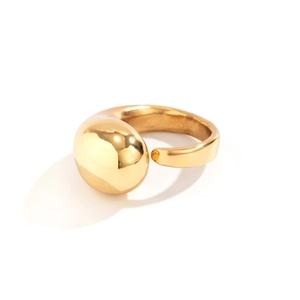 Macro shot of minimalist gold textured ring featuring a large polished spherical bead