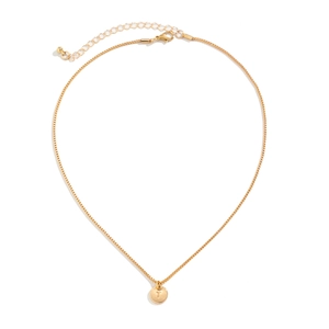 Detail of gold box chain necklace featuring a round pendant engraved with the letter T