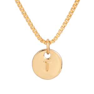 Macro shot of gold box chain and round pendant featuring engraved capital letter T