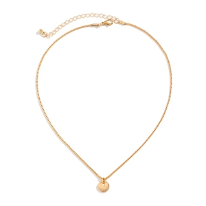 Detail view of gold round pendant featuring an engraved letter V with a delicate box chain