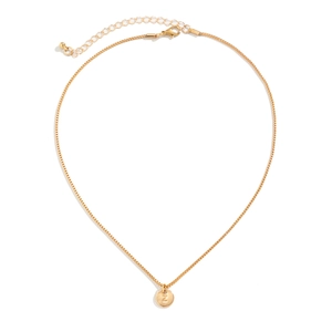 Minimalist gold-tone necklace with a Z-engraved circular pendant on a box chain