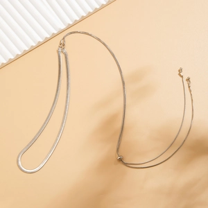 Detail of silver double layered snake bone chain with spherical adjustable metal bead