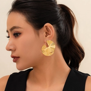 Close-up of gold-plated geometric pleated round earrings on an Asian female model