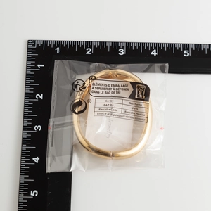 Misurazione delle dimensioni di un bracciale dorato lucido con scala graduata