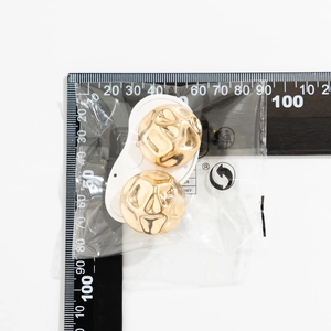 Detailed view of gold round textured stud earrings with a hammered finish and measurement