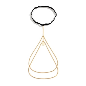 Detail of gold multi-layered leg chain featuring star pendant and black elastic strap