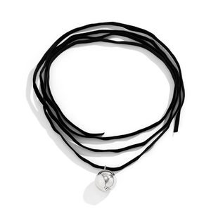 Close-up of black suede wrap necklace featuring a polished silver spherical pendant