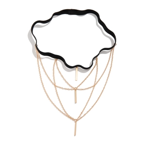 Star layered leg chain with gold tassels and black elastic strap on white background