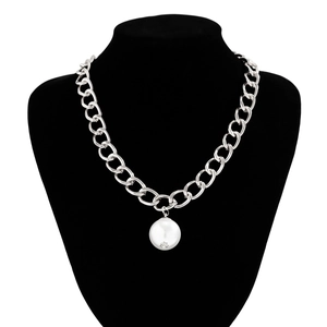 Macro detail of silver thick chain necklace with a large round faux pearl pendant