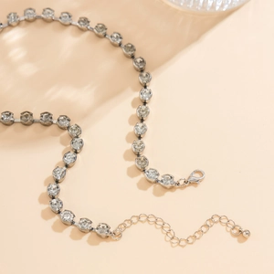 Detail of silver necklace with clear rhinestones, lobster clasp, and extension chain