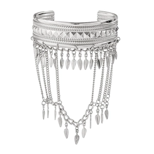 Close-up of silver tassel arm cuff with pyramid studs and leaf fringe details