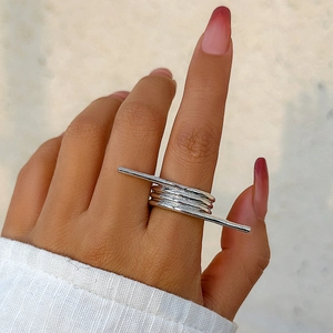 Detailed close-up of a silver spiral ring featuring a modern minimalist linear design