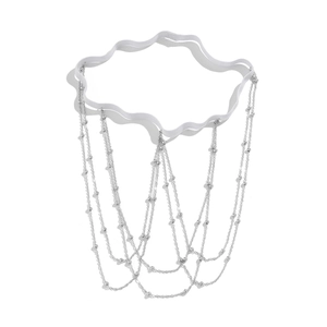 Detail showing multi-layer silver tassel leg chain with elastic band and metallic beads